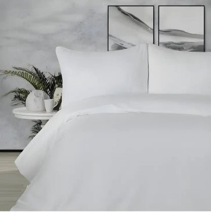 Crisp white bedding with duvet cover and pillows.