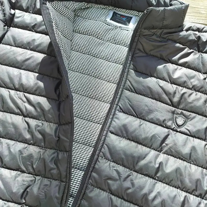 Grey quilted puffer vest with a checkered lining.