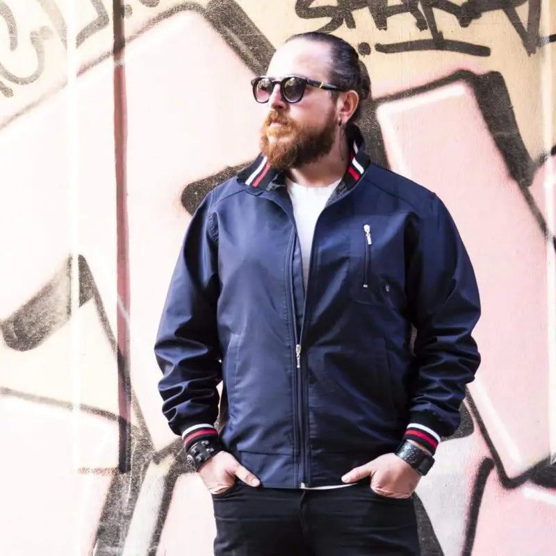 Navy blue bomber jacket with red and white striped ribbing at the collar and cuffs.