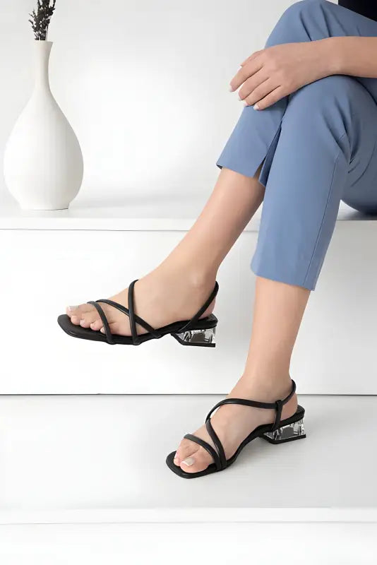 Black strappy sandals with clear block heels.