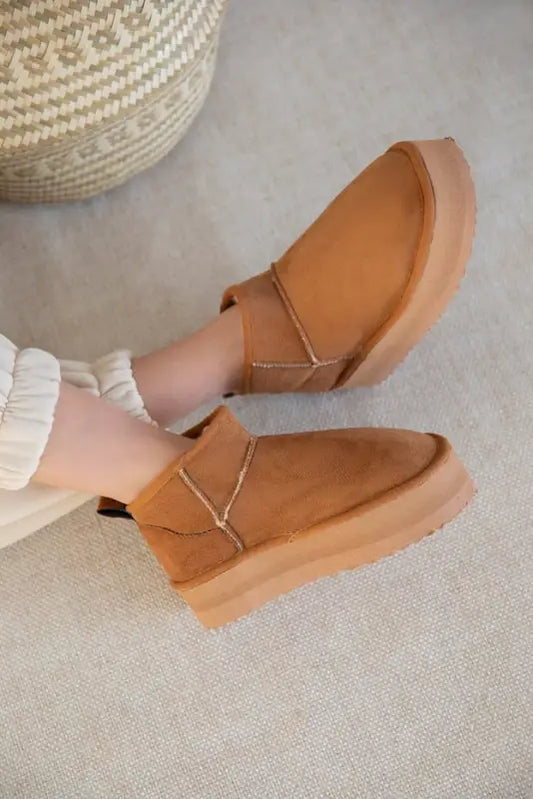 Tan leather slip-on shoes with elastic side panels and a chunky sole.