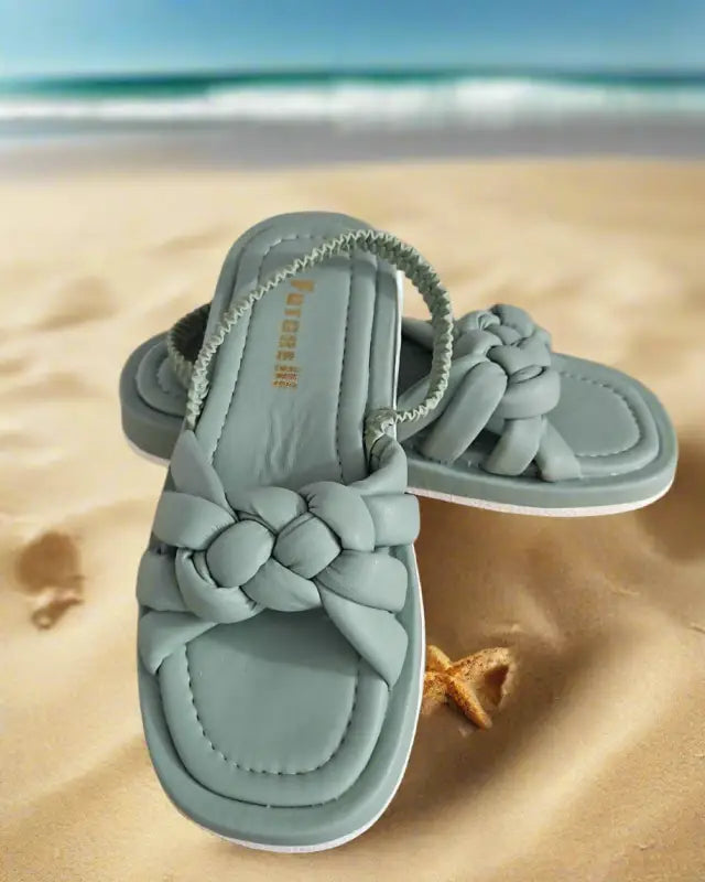 Light blue braided slide sandals with a woven strap design.