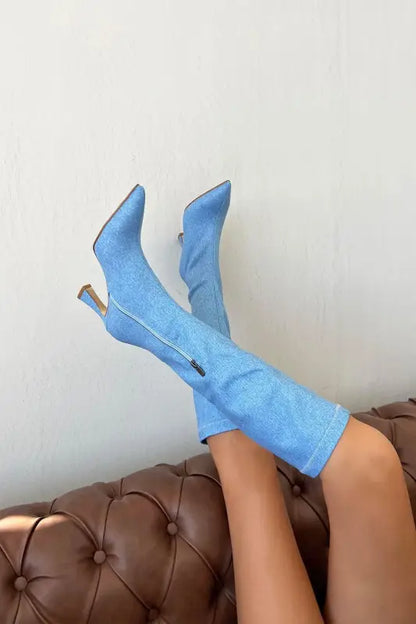 Light blue suede knee-high boots with stiletto heels.