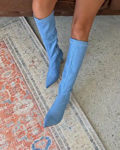 Light blue denim knee-high boots with pointed toes.