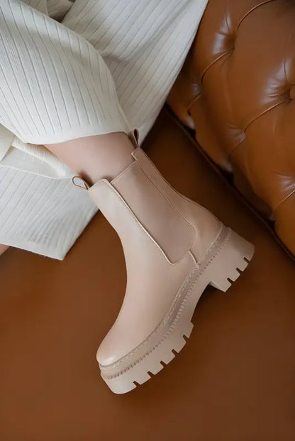 Beige chunky platform Chelsea boot with a thick rubber sole.