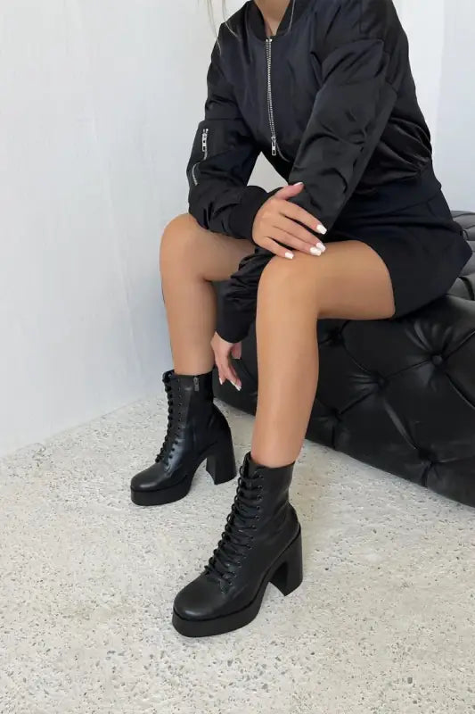 Black lace-up combat boots with a chunky heel.