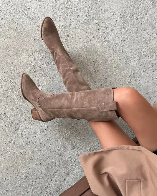 Tall taupe suede boots with a pointed toe and slouchy shaft.