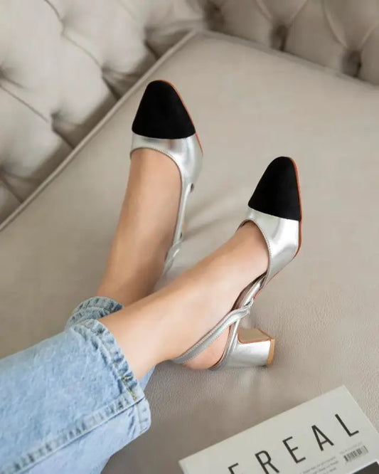 Silver and black two-tone slingback pumps with chunky heels.