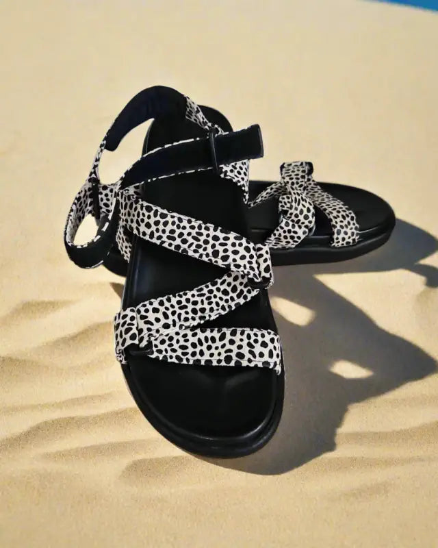 Black and white spotted strappy sandal with ankle ties.