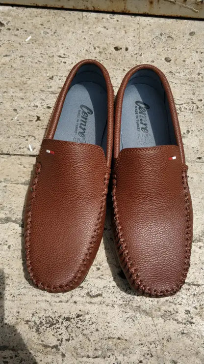 Brown leather loafers with moccasin-style stitching.