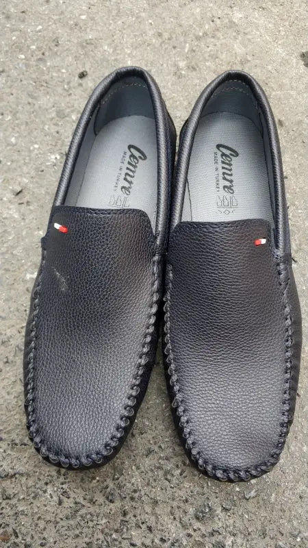 Black leather loafers with red and white stripe accents.