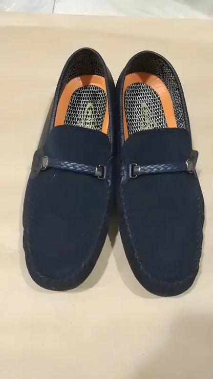 Navy blue suede loafers with braided leather details across the vamp.