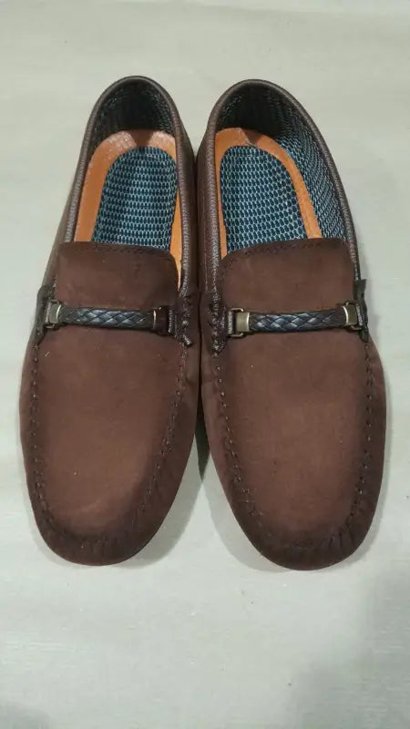 Brown leather loafers with braided strap details.