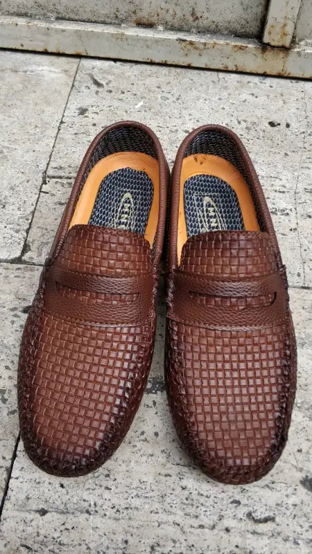 Brown woven leather loafers with a moccasin-style design.