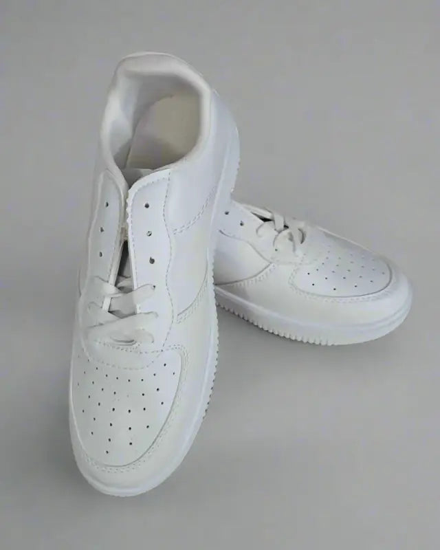 White perforated leather sneakers with laces.