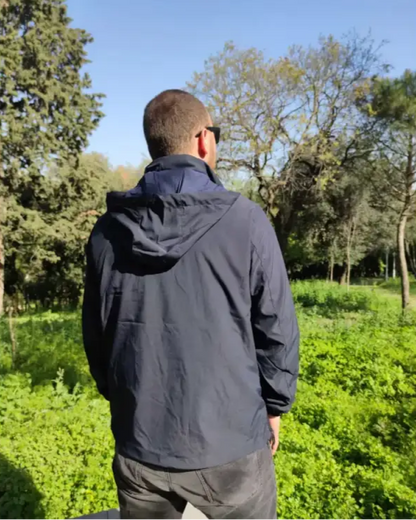 Navy blue hooded windbreaker jacket worn by someone.